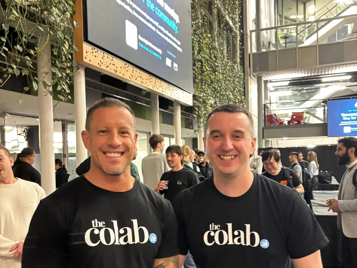 Colab co-founders Simon Conroy (left) and Adam Holt (right), smiling in matching theColab t-shirts at the Auckland meetup.